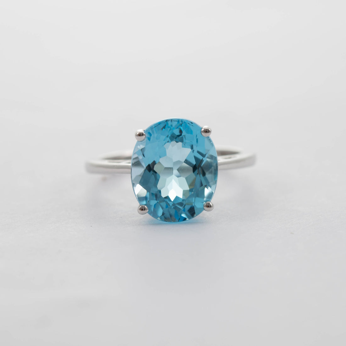 9CT WG LARGE OVAL BLUE TOPAZ SOLITAIRE RING 6.17CT