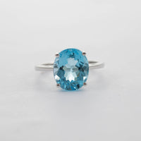 9CT WG LARGE OVAL BLUE TOPAZ SOLITAIRE RING 6.17CT